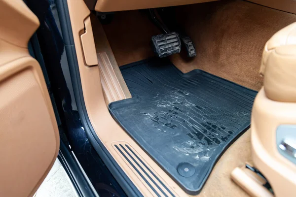 Dirty car floor mats of black rubber with gas pedals and brakes — Stock Photo, Image