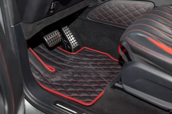 Dirty car floor mats of black rubber with gas pedals and brakes — Stock Photo, Image