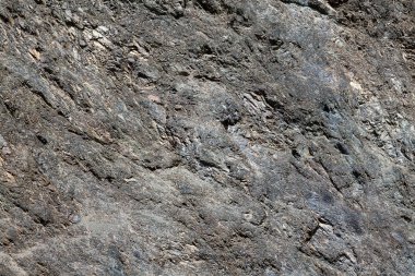 Gri ve kahverengi renkli taştan yapılmış kaba bir arkaplan