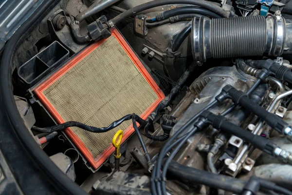 Close-up on a dirty air filter for an engine with an orange fram — Stock Photo, Image