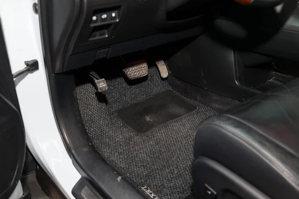 Dirty car floor mats of gray carpet with gas pedals and brakes i — Stock Photo, Image