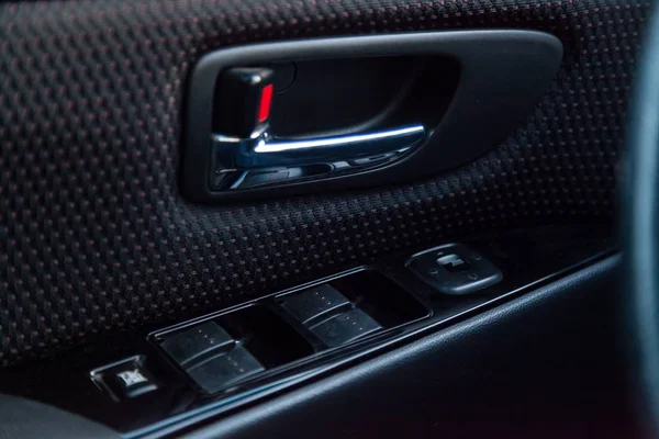 Interior view with drivers door, window buttons and armrest of b — Stock Photo, Image