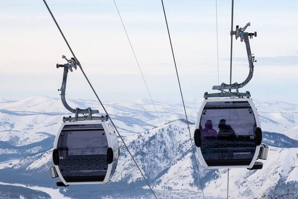 Cabin of a gondola cableway suspended on a rope where sits peopl — Stock Photo, Image