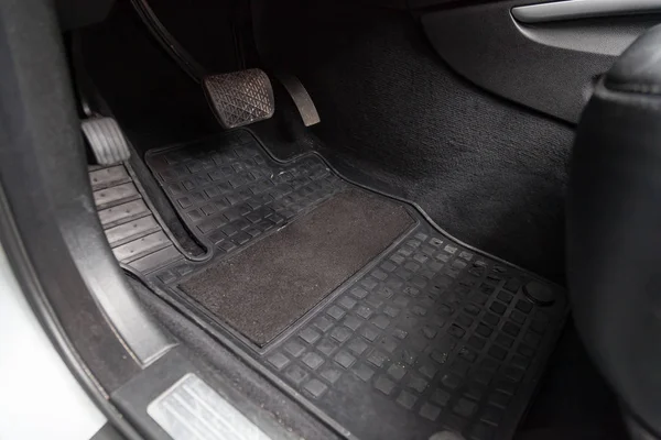 Dirty car floor mats of gray carpet with gas pedals and brakes i — Stock Photo, Image