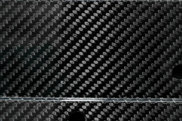 Close-up on interwoven carbon fiber lacquered in black and gray — 스톡 사진