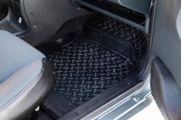 Dirty car floor mats of black rubber under passenger seat in the — Stock Photo, Image