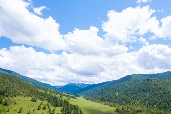 Aerial landscape with mountains, green trees, field, road and ri — Stock Photo, Image