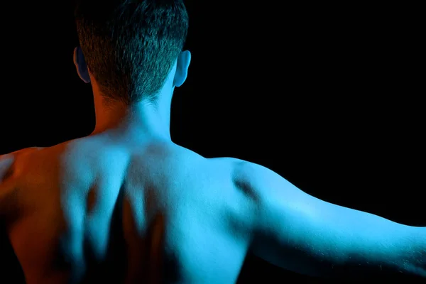Close-up of nape, back and shoulders with strained muscles and h