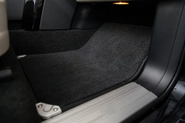 Clean car floor mats of black carpet under front passenger seat — 스톡 사진