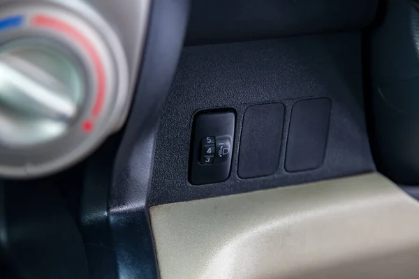 Black button for turning electric headlight range adjustment of — Stock Photo, Image