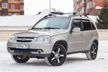 Novosibirsk, Russia - 02.18.2020: Front view of a Chevrolet Niva, a Russian-American car in the snow in winter
