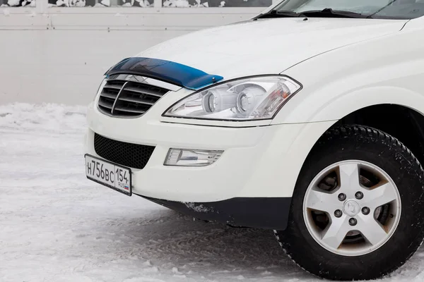 Novosibirsk, Russia - 02.26.2020: Used white Ssangyong Kyron with an engine of 2.3 liters front view on the car snow parking after preparing for sale