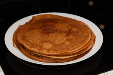 Evde kahvaltıda bir kap süt, un ve yumurta içinde pişirilmiş lezzetli ve taze krep yığını. Rus ulusal bayramı Shrovetide.