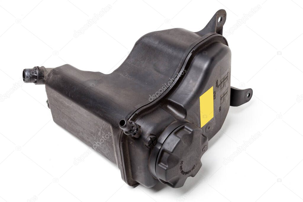 Coolant expansion tank in black on a white isolated background with a yellow nameplate. The unit of the liquid cooling system of internal combustion engines, the capacity of a special design.