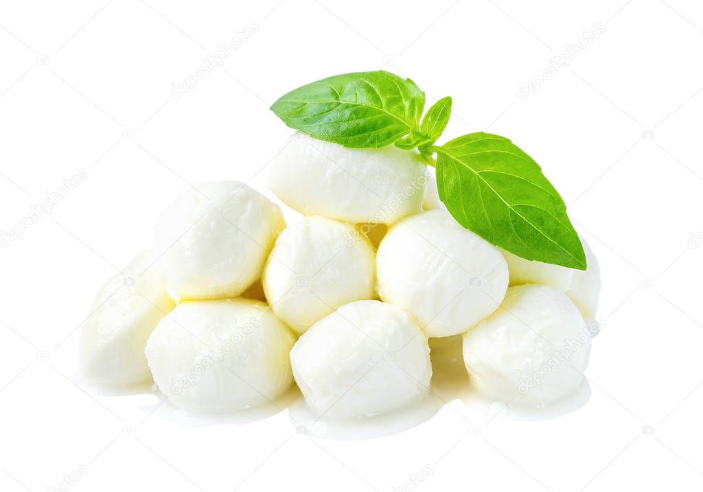 Heap of mini mozzarella cheese balls and basil isolated.