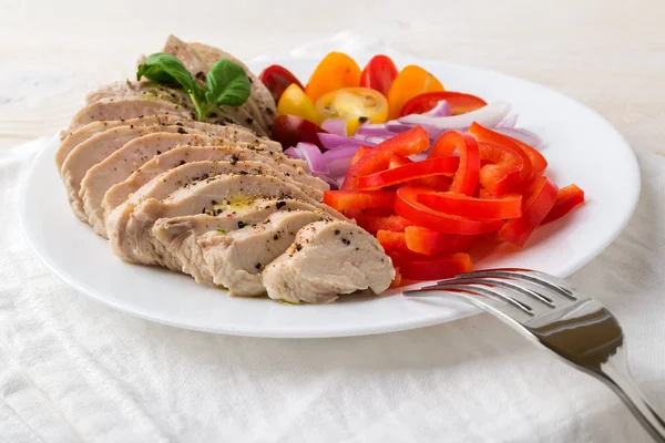 Sliced chicken fillet cooked under vacuum at low temperature.