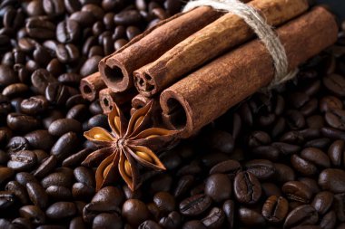 Star anise and cinnamon sticks on a roasted coffee beans