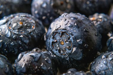 Macro photography of ripe juicy blueberries with water droplets. Fruits and berries, vegetarian and healthy eating. Super food. Ready to eat. Close-up. clipart