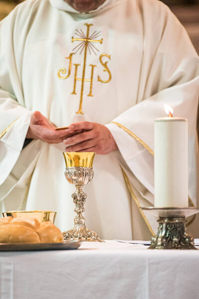 Minister showing the holy bread during the rite of the Holy Communion during the catholic mass