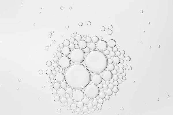 Oil drops in water on a white background — Stock Photo, Image