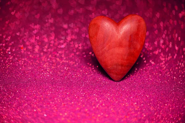 Wooden red heart on a red blurred background — Stock Photo, Image