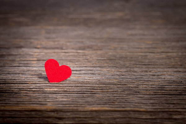 Red heart on old wooden background