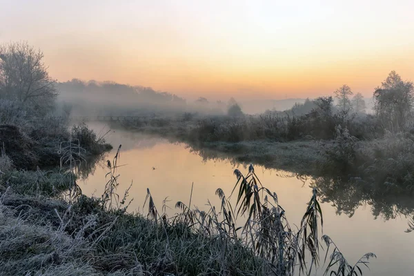 Ein schöner Sonnenaufgang über dem nebligen Fluss. — Stockfoto