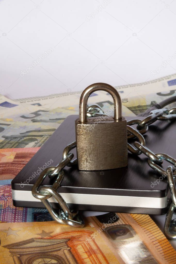 Protected external hard drive and Money. Padlock and chain on hard drive. Front view padlock and Money. Data security concept