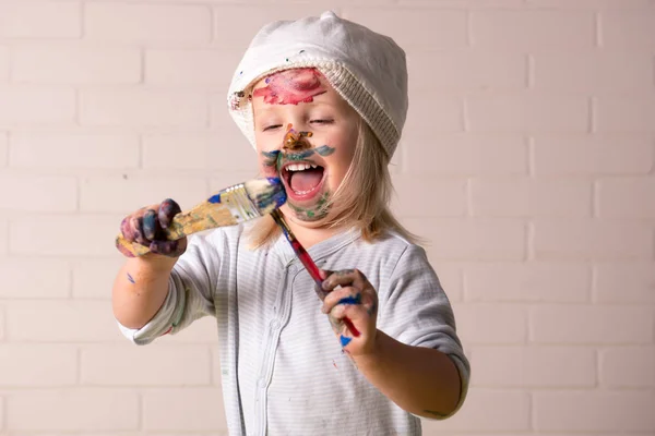 Маленькая девочка играет яркими красками Стоковое Изображение