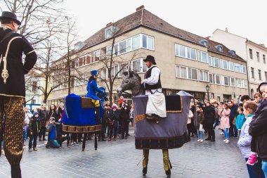 BUDAPEST - MARCH 15: Performance of artists on stilts on a street in the Buda Castle on the day of the Hungarian National Revolution on March 15, 2019 in Budapest.
