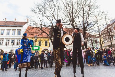 BUDAPEST - MARCH 15: Performance of artists on stilts on a street in the Buda Castle on the day of the Hungarian National Revolution on March 15, 2019 in Budapest.