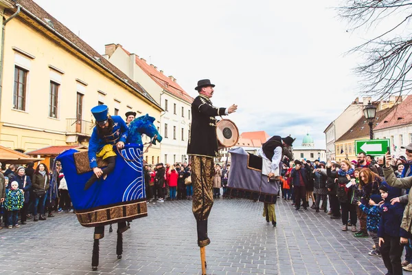 BUDAPEST - MARCH 15: Performance of artists on stilts on a street in the Buda Castle on the day of the Hungarian National Revolution on March 15, 2019 in Budapest. — стокове фото