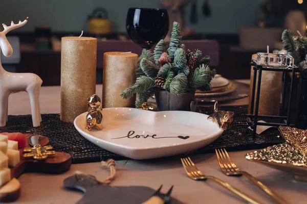 Thanksgiving table setting among white candles and cones — Stock Photo, Image
