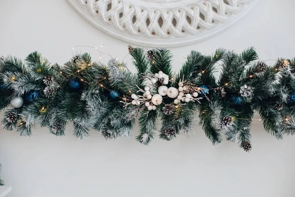 Beautiful fireplace with mirror and fur branches. — Stock Photo, Image