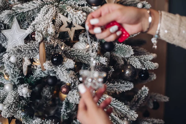 Donna che mette il giocattolo di Natale sull'albero — Foto Stock