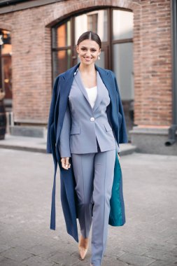 Beautiful stylish lady in blue coat and heels.
