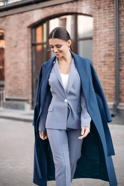 Attractive cheerful brunette in suit and coat. — 图库照片