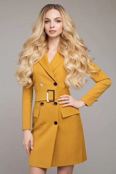 Fashion beautiful young lady with makeup standing in studio