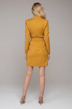 Fashion beautiful young lady with makeup standing in studio