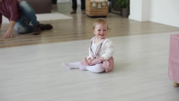 Laughing cute little infant girl playing with ball at home carpet having fun — Stock Video