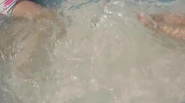 Wavy water in outdoors pool.
