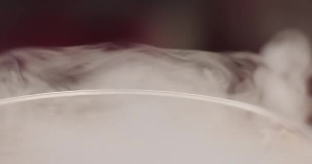 Close up realistic dry ice at glass bowl covered by dense smoke 4k footage — Αρχείο Βίντεο