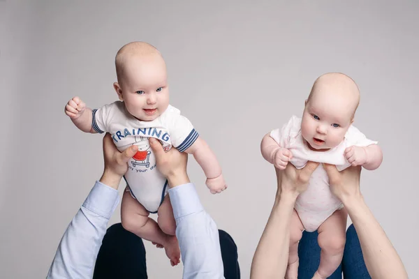 Les parents tiennent leurs enfants sur leurs mains et les ramassent — Photo