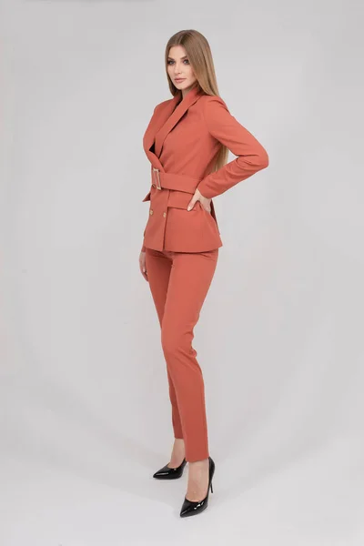 Adorable young fashion female model posing in trendy pantsuit full length isolated — Stockfoto