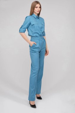 Beautiful young model in blue suit and heels.