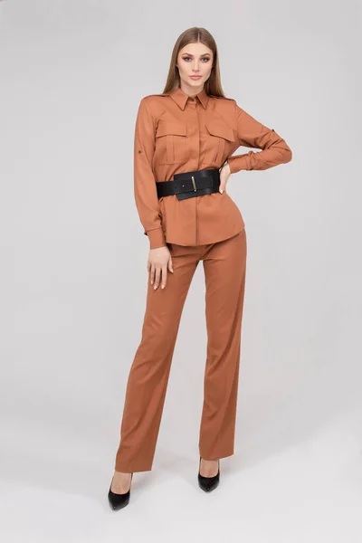 Fashionable young stylish woman posing in pantsuit with black belt — Stockfoto
