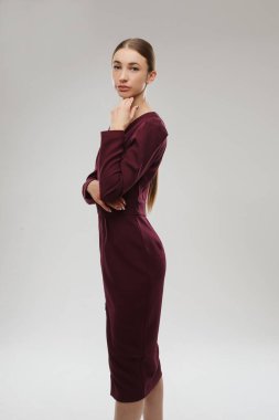 Smiling pretty lady with with long wavy hair looking at camera