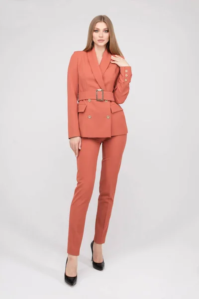 Adorable young fashion female model posing in trendy pantsuit full length isolated — Stockfoto