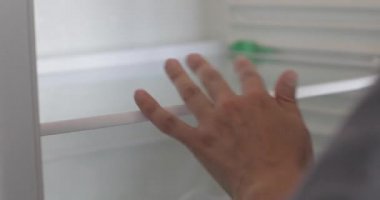 Female hand is cleaning inside the refrigerator