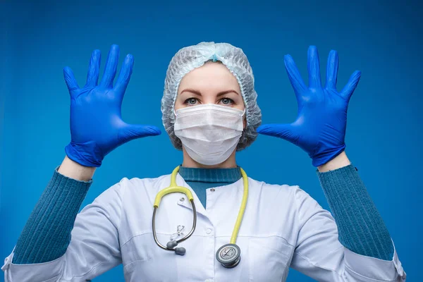 Доктор показує свої руки в синіх захисних рукавичках . — стокове фото